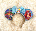 A Mermaid's Wish Boutique Mouse Ear Headband featuring enchanting ocean-inspired artwork, an aqua blue sequin bow, and handcrafted boutique detailing.