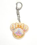 Golden Kingdom Pocket Charm featuring a resin mouse-ear charm with an enchanted castle, golden crown bow, floral accents, and silver lobster clasp.