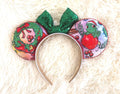 Holiday Magic Boutique Mouse Ear Headband featuring festive holiday artwork, an emerald green sequined bow, and handcrafted boutique detailing.