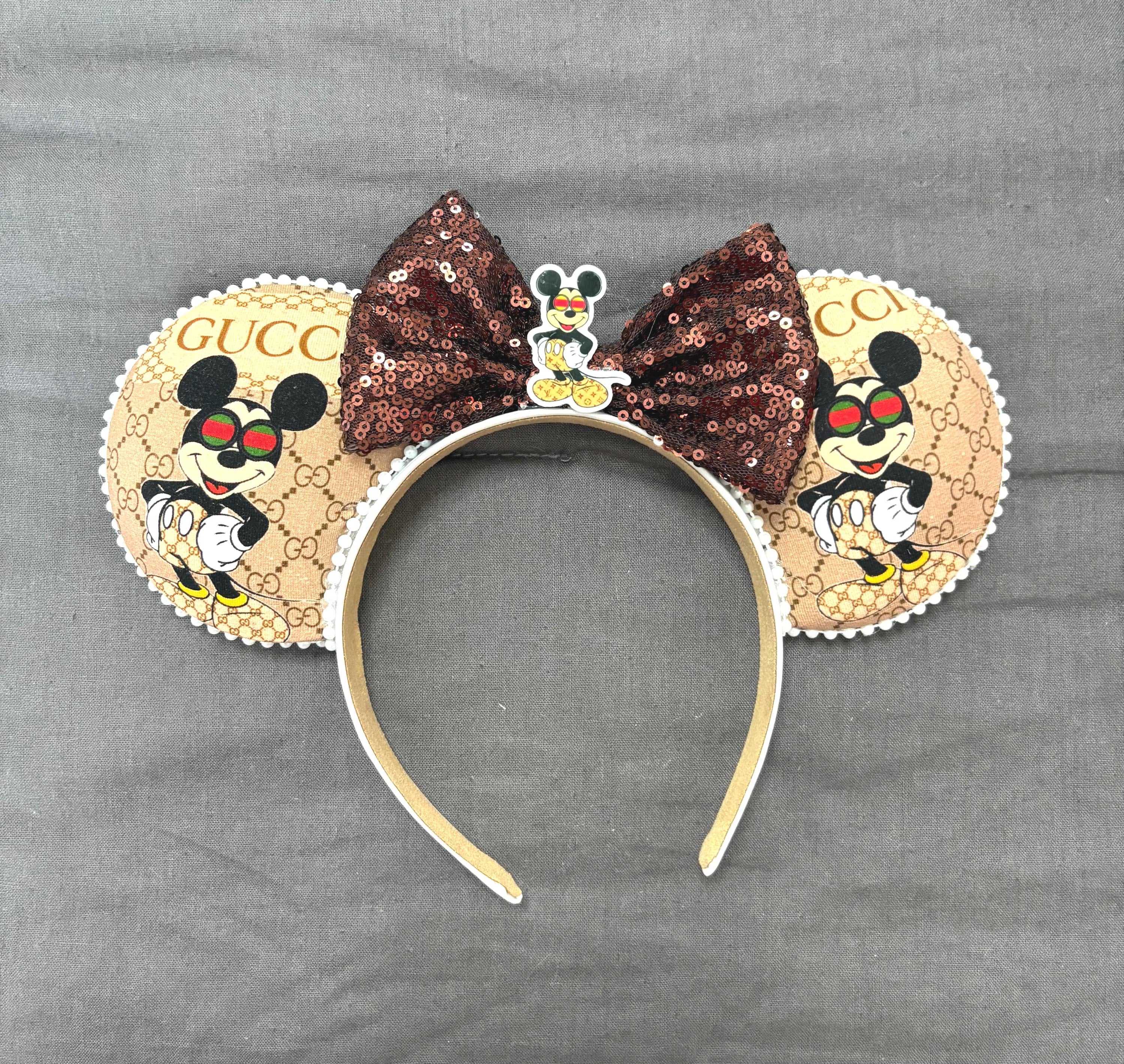Handcrafted Espresso Chic boutique mouse ear headband featuring designer-inspired tan fashion print, rich espresso sequin bow, decorative resin centerpiece, and lightweight comfort-fit headband.