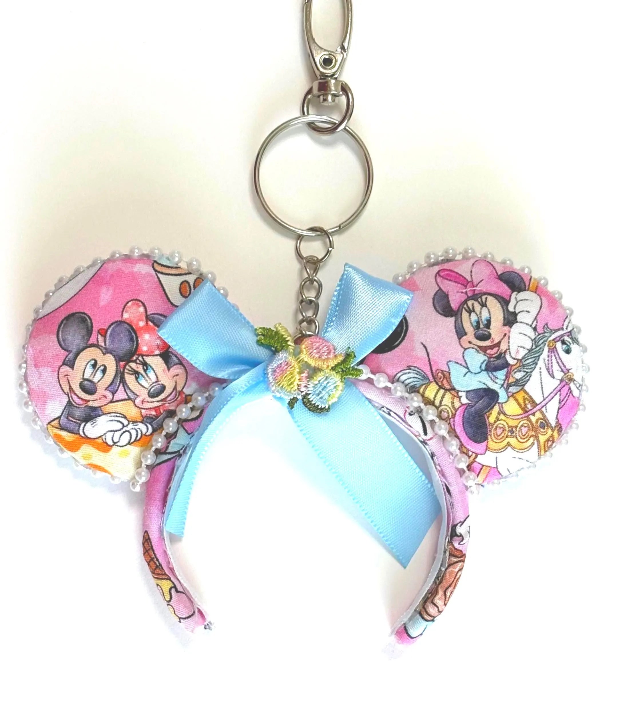 Handcrafted Park Magic Mini Ear Keychain & Bag Charm featuring colorful park-inspired artwork, pastel blue bow, floral accent, and clasp hardware for backpacks, purses, luggage, and keys.