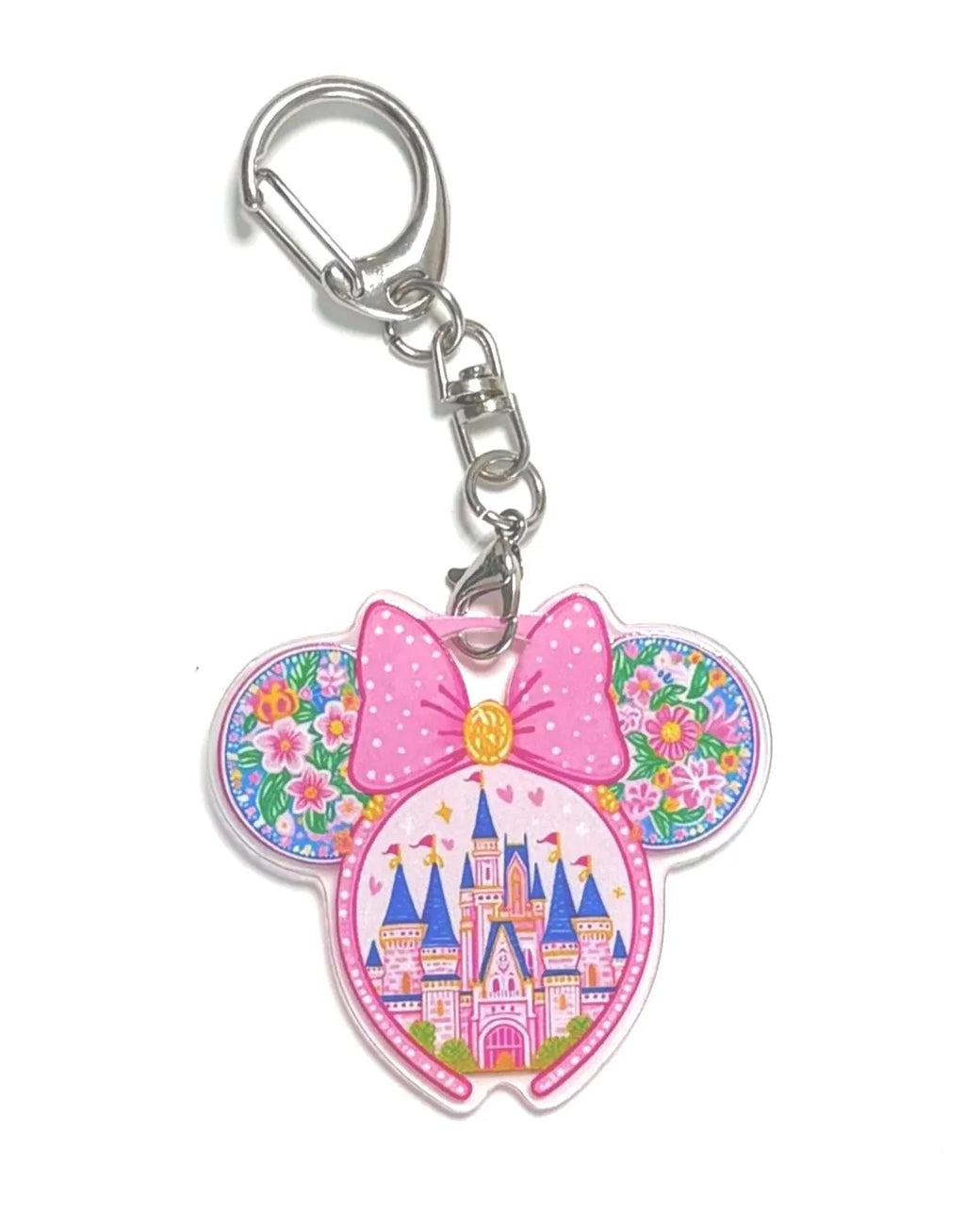 Castle in Bloom Pocket Charm featuring a pink bow, floral mouse ears, and a colorful storybook castle on a premium resin bag charm with lobster clasp