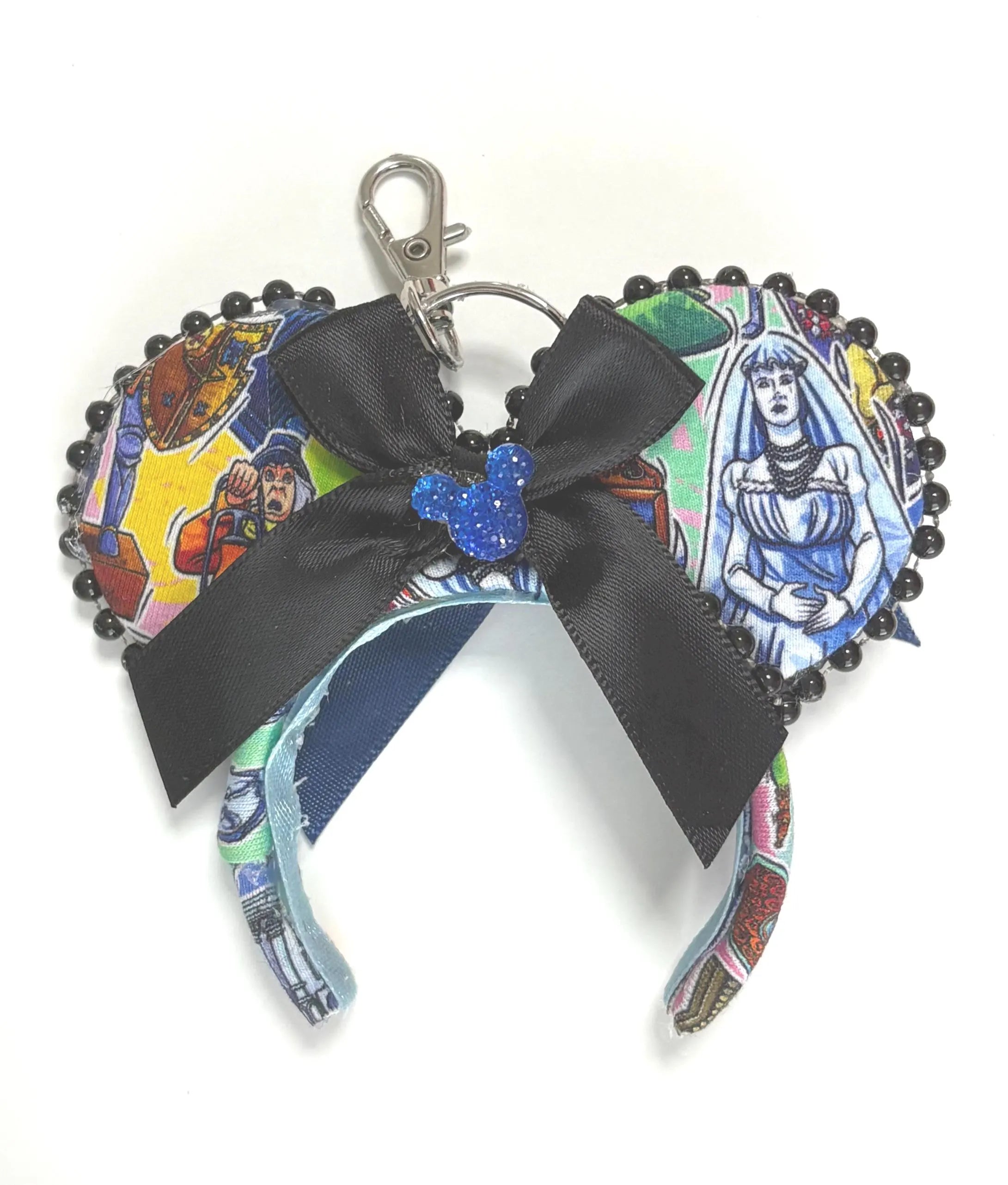 Haunted Manor Mini Ear Keychain and Bag Charm featuring haunted mansion-inspired artwork, satin black bow, black pearl trim, and handcrafted boutique styling by Pixie Park Co.