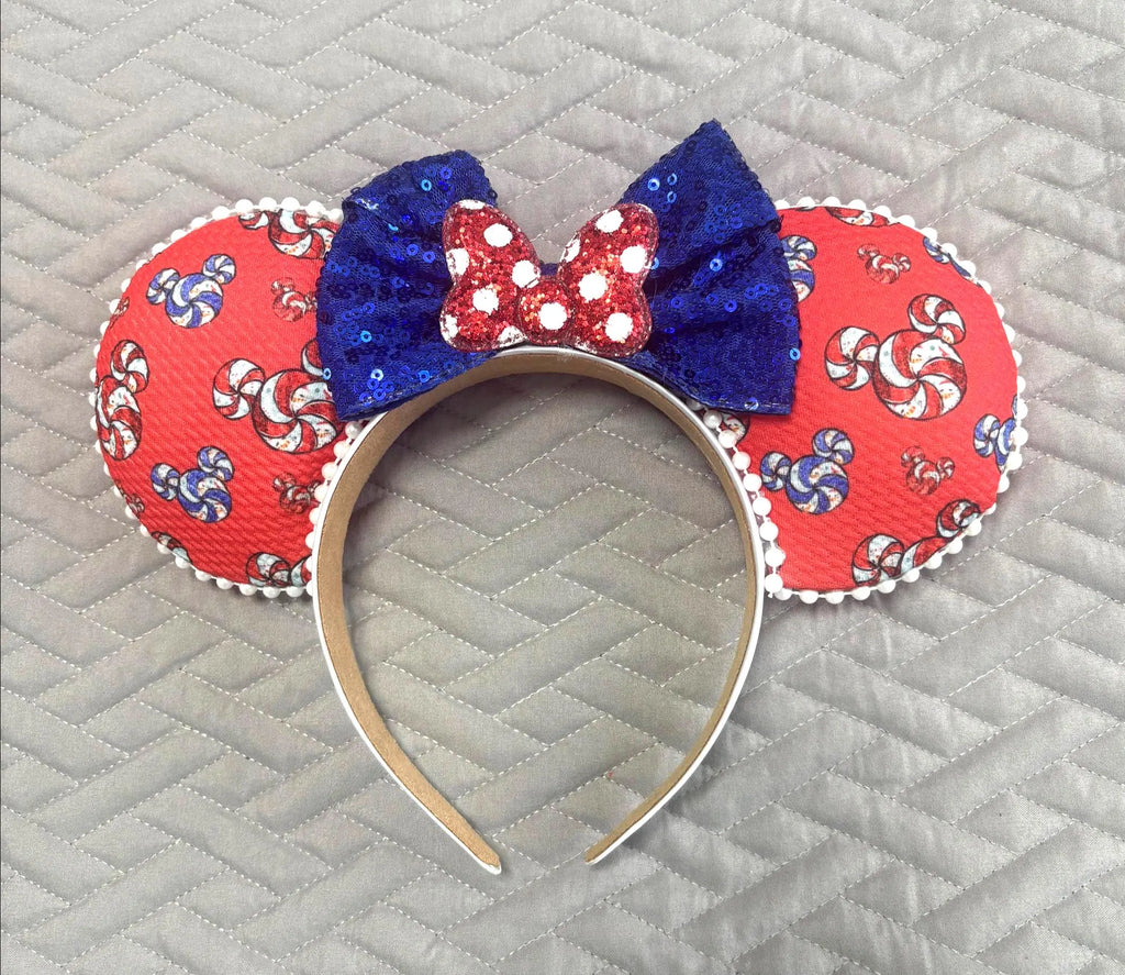 Main Street Sweets Boutique Mouse Ear Headband featuring colorful candy-inspired pinwheel print, royal blue sequin bow, and handcrafted boutique styling by Pixie Park Co.