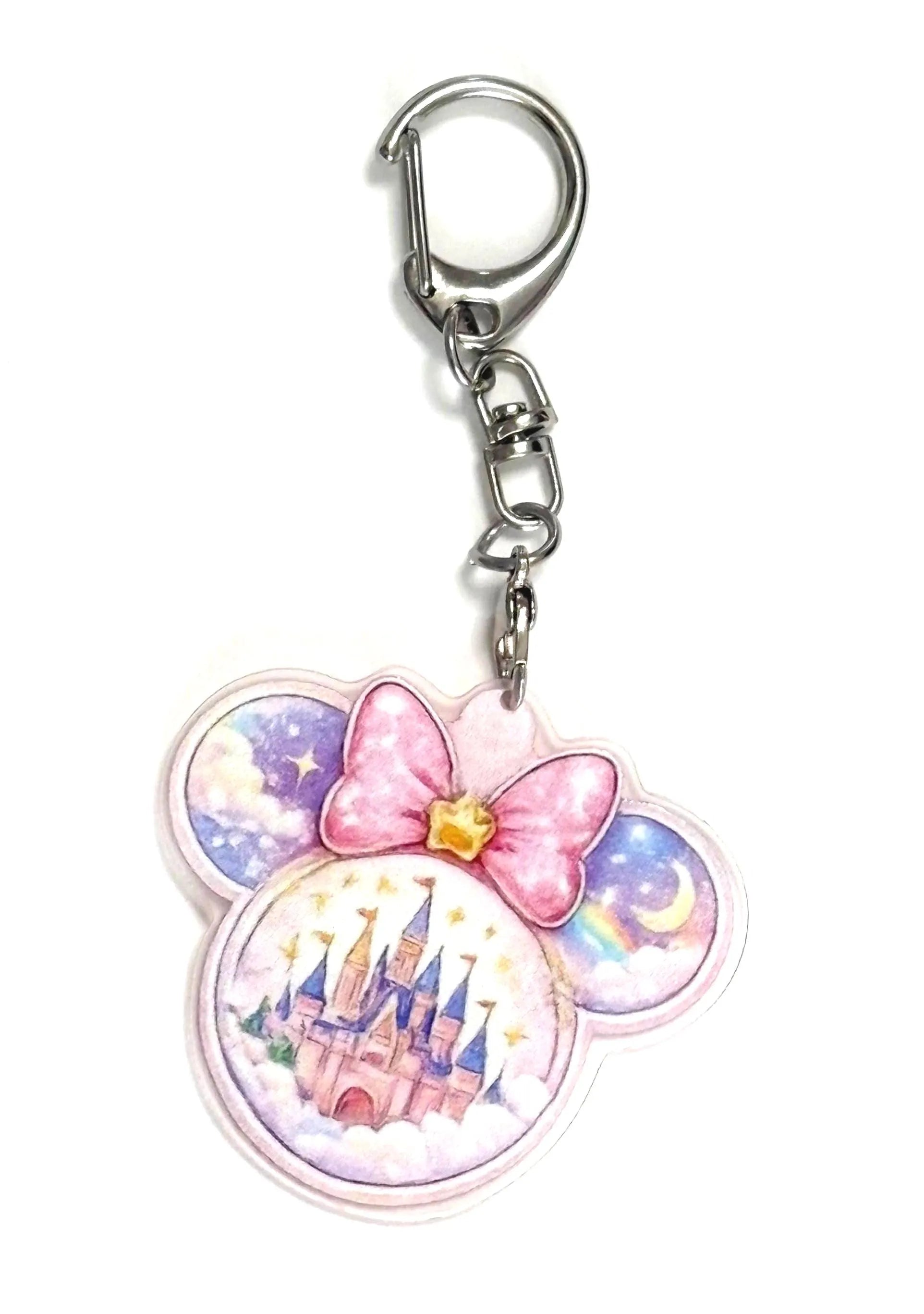 Starlight Castle Pocket Charm featuring a pastel storybook castle, pink bow, stars, moon, rainbow, and clouds on a premium resin bag charm with lobster clasp.