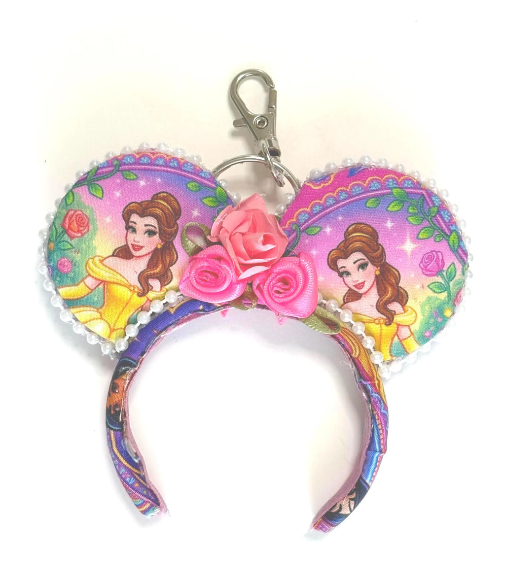 Handcrafted Village Beauty mini ear keychain featuring storybook-inspired artwork, pink floral embellishments, pearl trim, silver clasp, and boutique styling by Pixie Park Co.