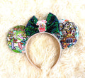 Jungle Expedition Boutique Mouse Ear Headband featuring a colorful safari-inspired character print, emerald green sequin bow, adventure-themed centerpiece, and handcrafted boutique styling by Pixie Park Co.
