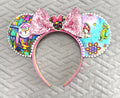 Whimsy in the Kingdom Boutique Mouse Ear Headband featuring colorful fantasy-inspired artwork, a pink sequined bow, and handcrafted boutique detailing.