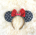 Handcrafted Metro Chic boutique mouse ear headband featuring designer-inspired black-and-white fabric, a red sequin bow, pearl trim, decorative mouse bow centerpiece, and lightweight comfort-fit headband.