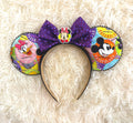 Park Insider Boutique Mouse Ear Headband with colorful park-inspired artwork, purple sequin bow, black pearl trim, and character centerpiece by Pixie Park Co.