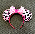 Wild at Heart Boutique Mouse Ear Headband featuring a pink leopard-inspired print, plush pink bow, and handcrafted boutique detailing.