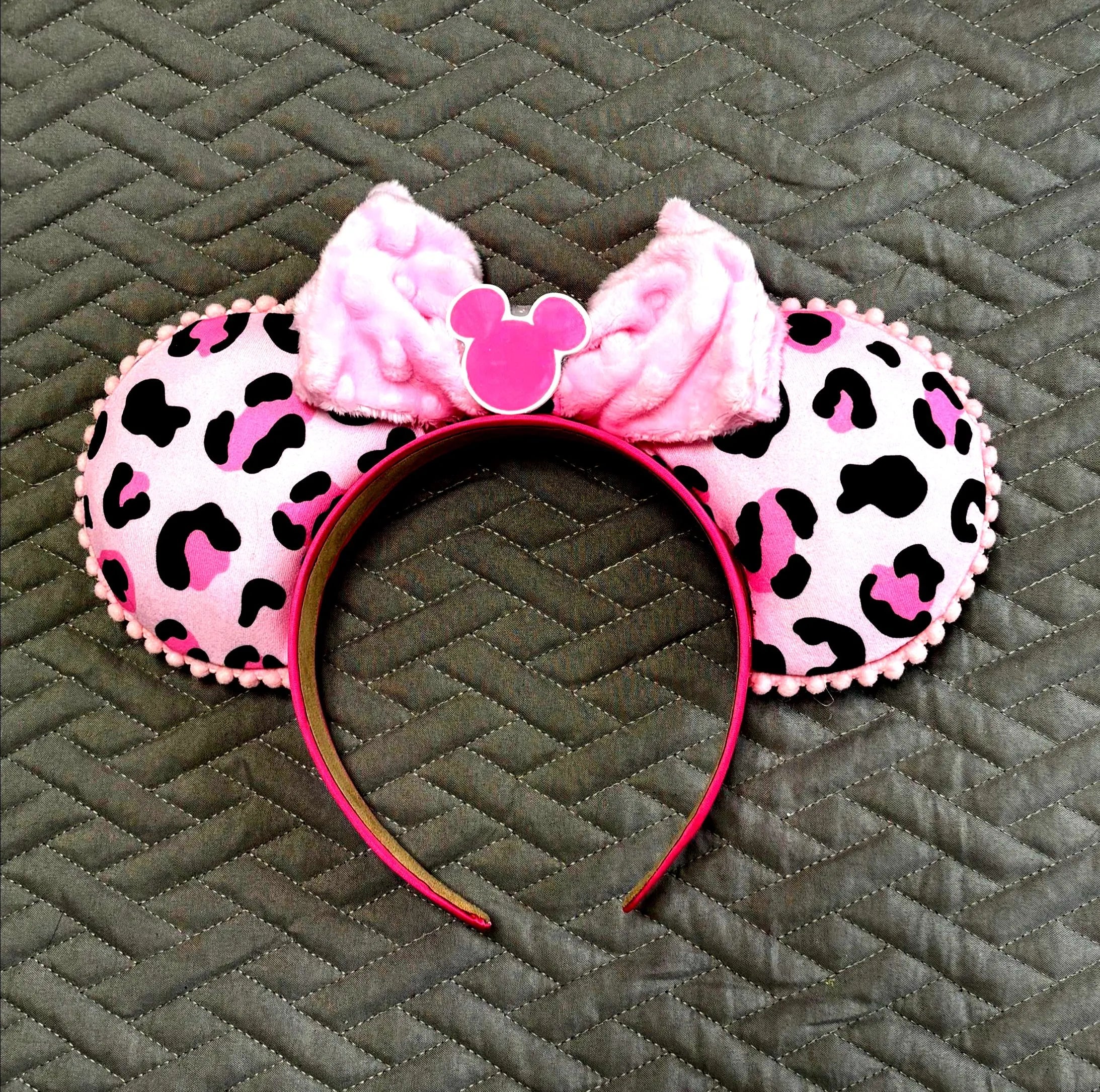 Wild at Heart Boutique Mouse Ear Headband featuring a pink leopard-inspired print, plush pink bow, and handcrafted boutique detailing.