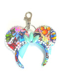 Park Celebration Mini Ear Keychain and Bag Charm featuring colorful park-inspired artwork, mint ribbon bow, pearl trim, and handcrafted boutique styling by Pixie Park Co.