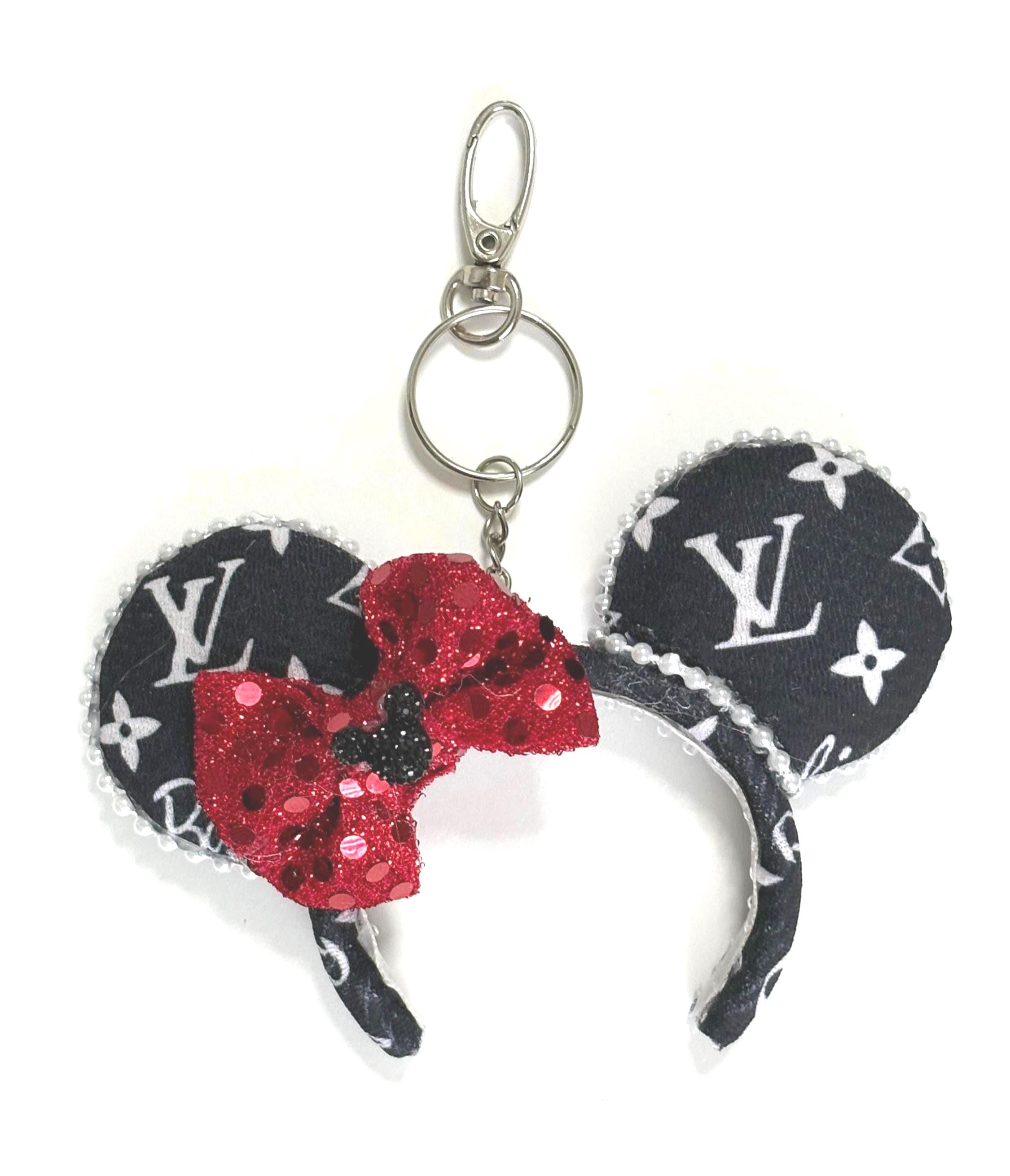 Handcrafted Metropolitan Chic mini ear keychain featuring black-and-white boutique-inspired fabric, sparkling red sequin bow, pearl trim, silver clasp, and handcrafted styling by Pixie Park Co.