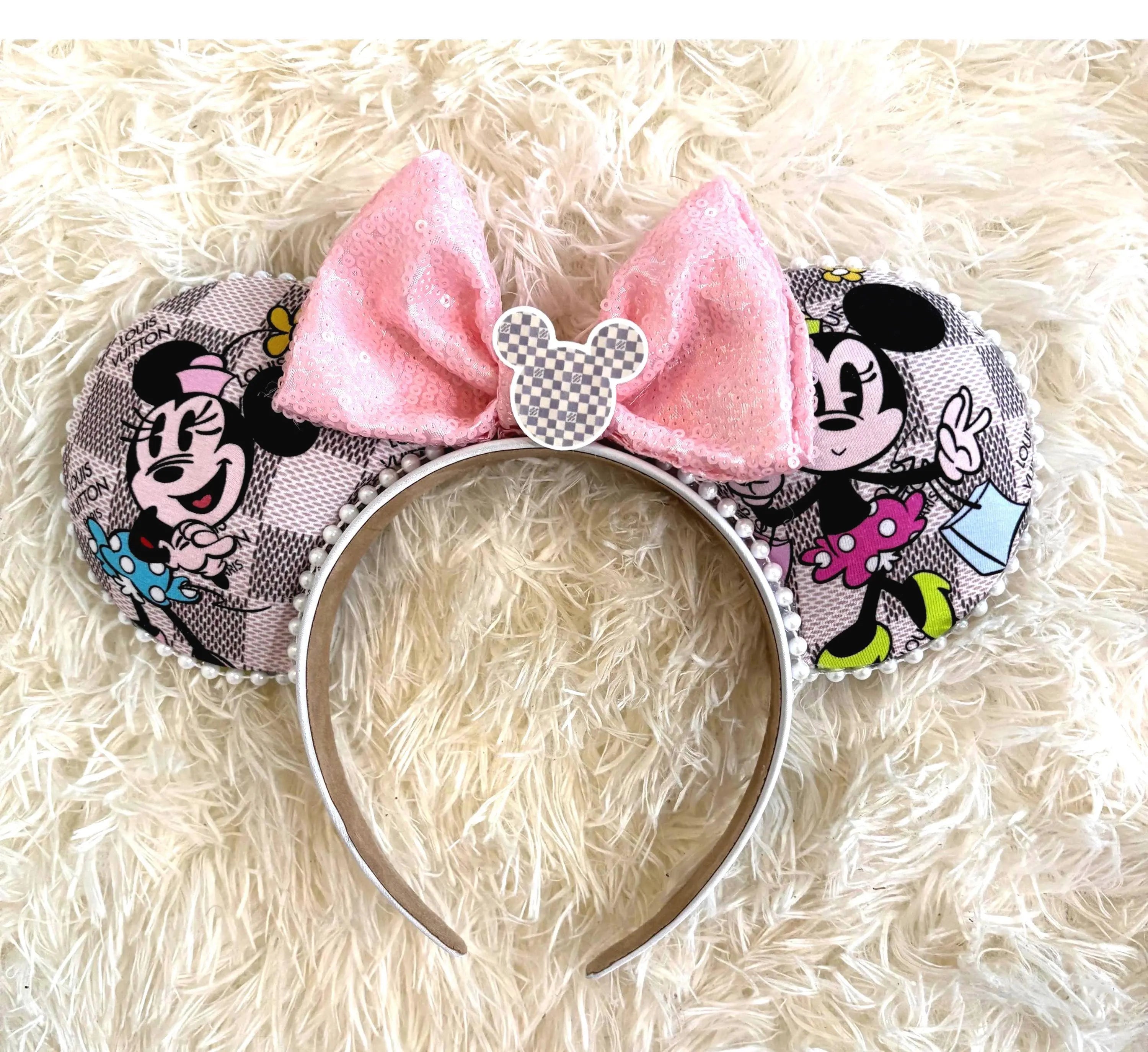Handcrafted Retail Therapy Boutique mouse ear headband featuring a blush designer-inspired print with shopping-themed mouse artwork, a pink sequin bow, pearl trim, decorative mouse silhouette centerpiece, and a lightweight comfort-fit headband.