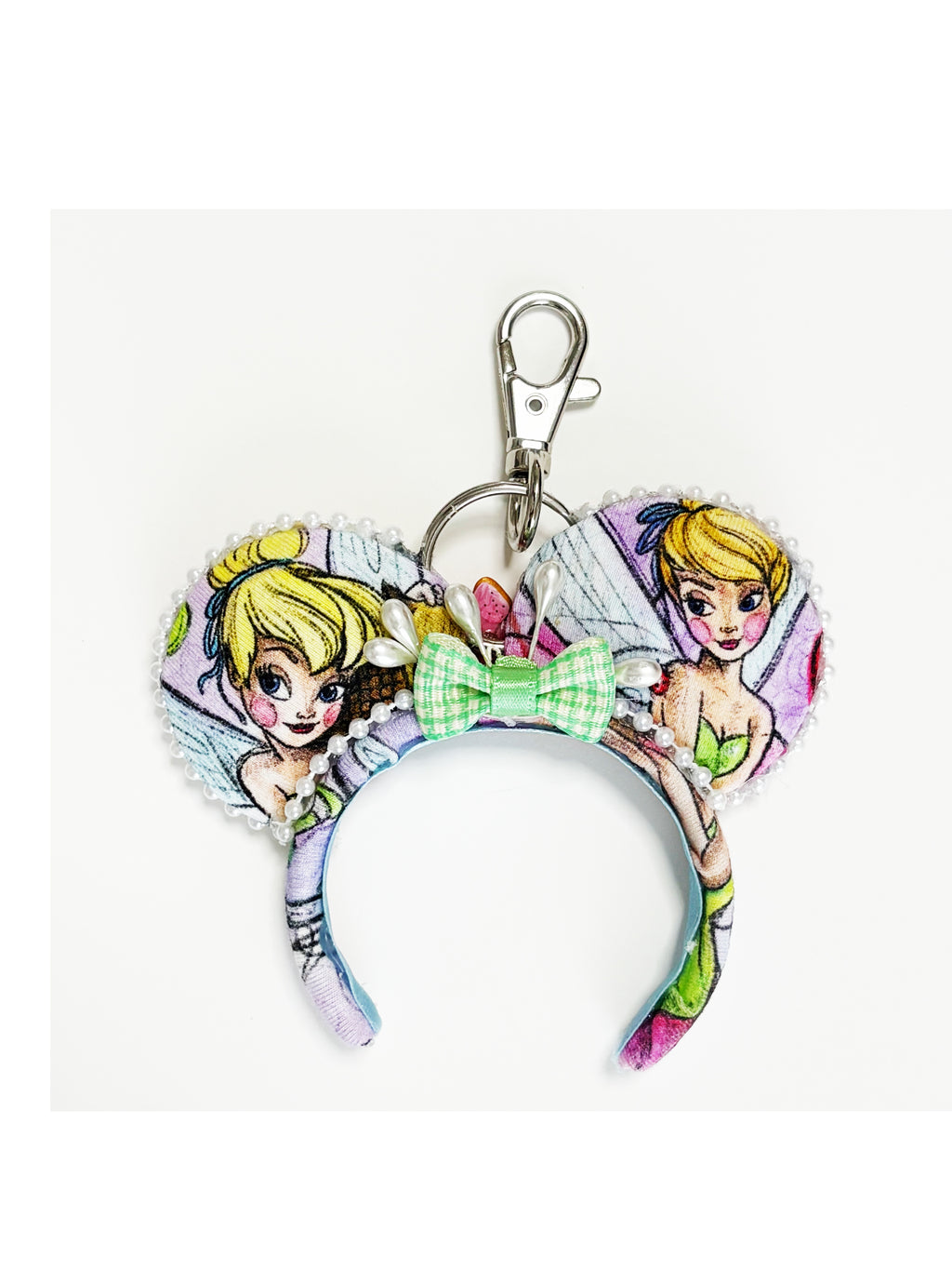 Handcrafted Pixie Dust mini ear keychain featuring fairy-inspired artwork, green sequin bow, pearl trim, silver key ring, and boutique styling by Pixie Park Co.
