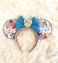 Storybook Belle Boutique Mouse Ear Headband with fairy tale-inspired artwork, sparkling sapphire blue sequin bow, handcrafted boutique styling, and comfort-fit headband by Pixie Park Company.