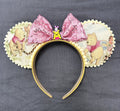 Handcrafted Forest Friends mouse ear headband featuring vintage woodland-inspired artwork, cream pom-pom trim, and a blush pink sequin bow.
