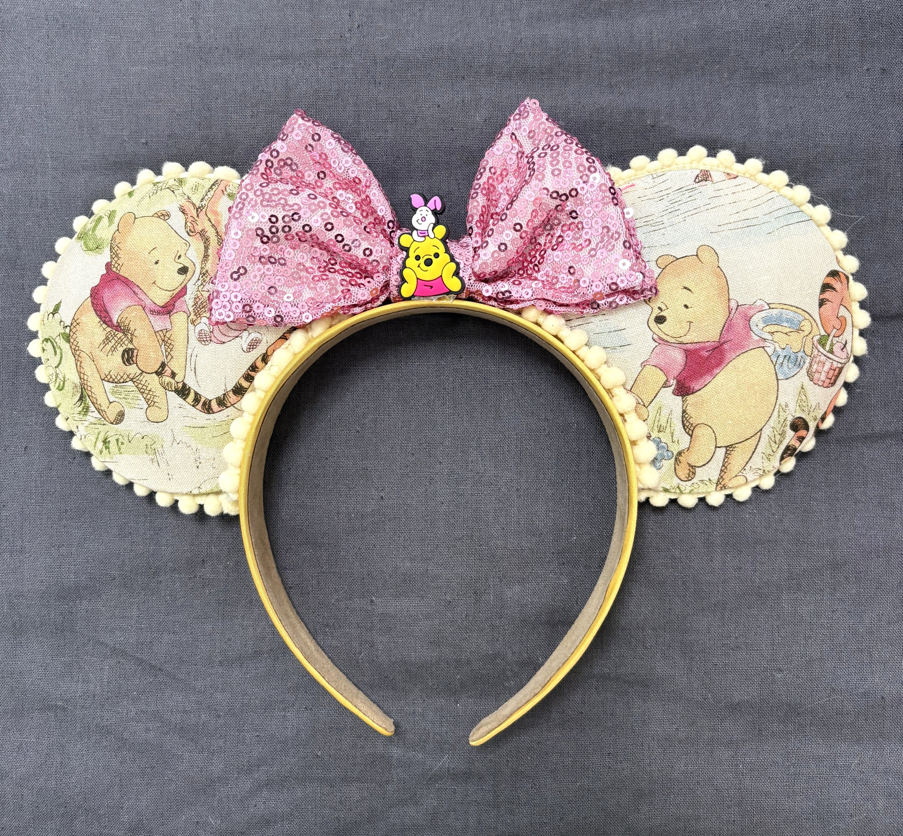 Handcrafted Forest Friends mouse ear headband featuring vintage woodland-inspired artwork, cream pom-pom trim, and a blush pink sequin bow.