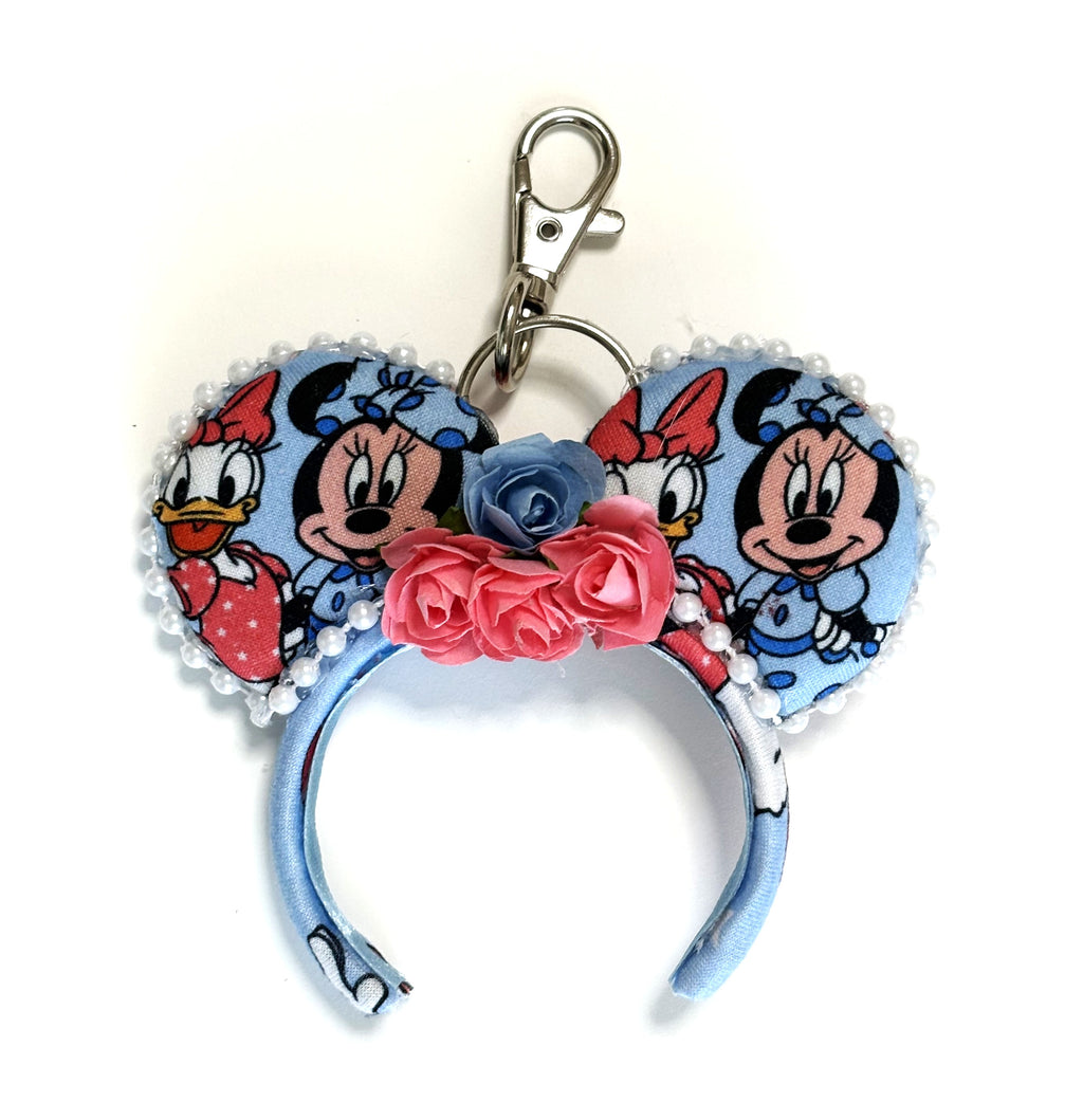 Handcrafted Besties Forever mini mouse ear bag charm featuring friendship-inspired artwork, handcrafted pink and blue floral accents, decorative beaded trim, and boutique styling for handbags, backpacks, luggage, and keychains.