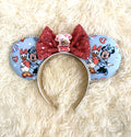 Handcrafted friendship-inspired mouse ear headband featuring two classic best friends on pastel blue fabric with a sparkling red sequin bow and boutique handcrafted styling.