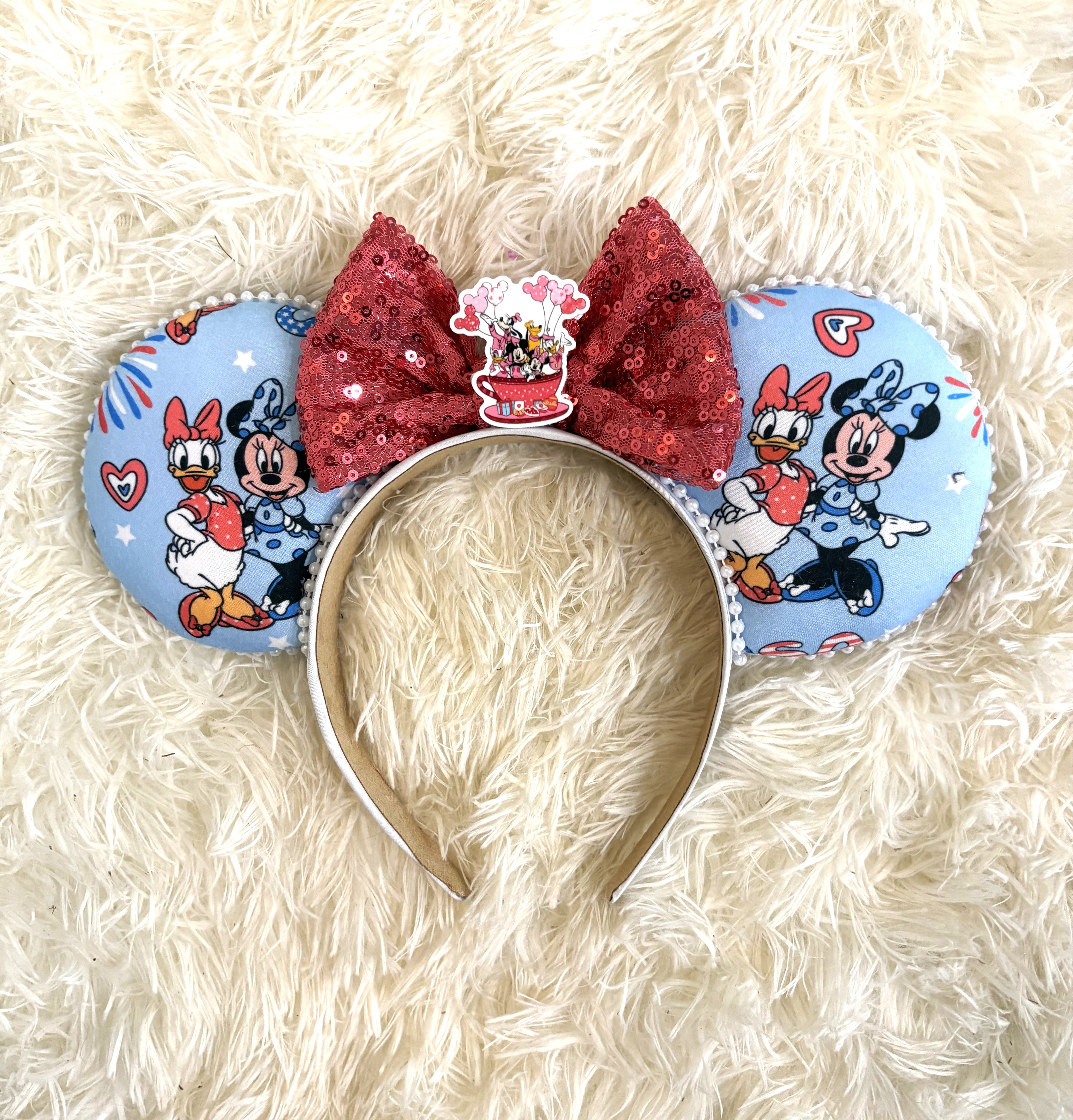 Handcrafted friendship-inspired mouse ear headband featuring two classic best friends on pastel blue fabric with a sparkling red sequin bow and boutique handcrafted styling.