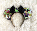 Handcrafted Halloween mouse ear headband featuring playful vampire-inspired artwork, festive treats, candy corn accents, and a sparkling black sequin bow.