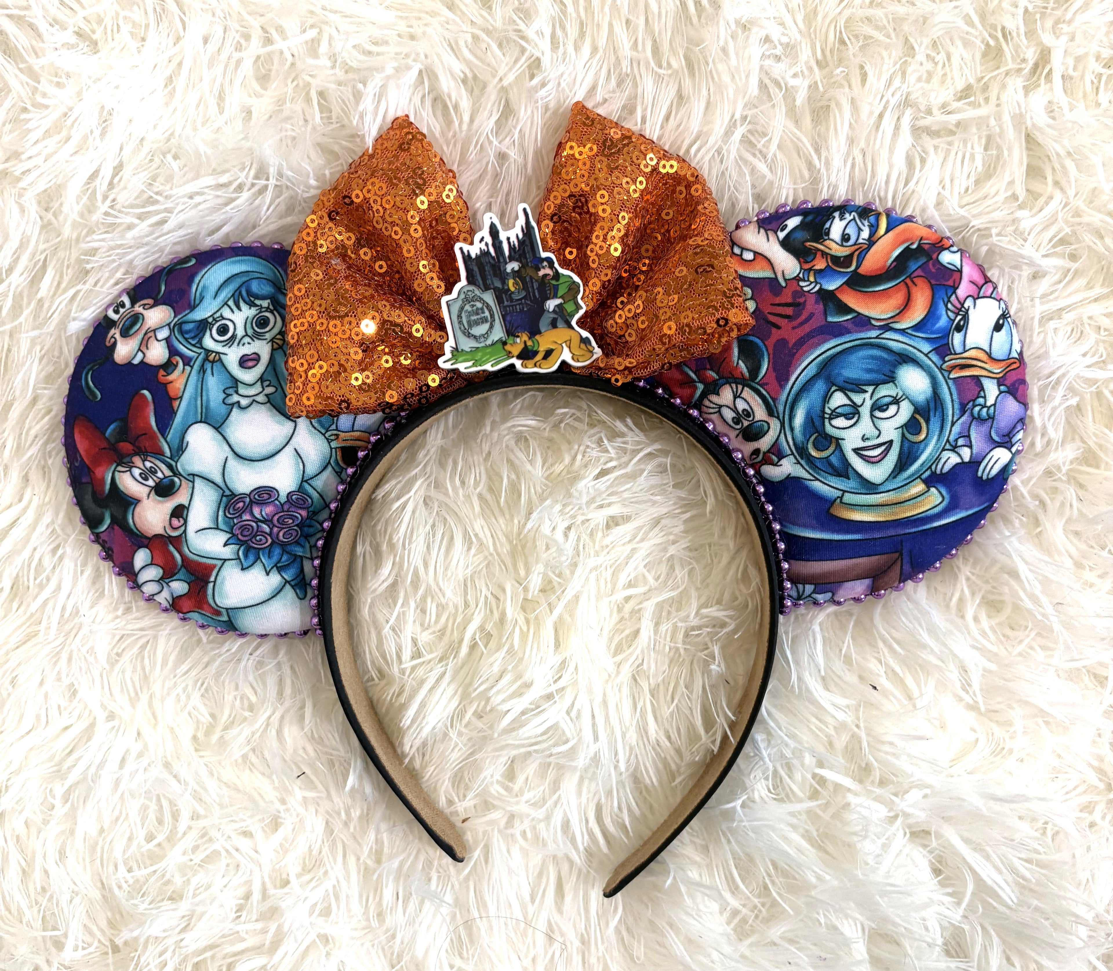 Handcrafted Ghostly Gathering Signature mouse ear headband featuring Halloween-inspired ghostly artwork, a shimmering orange sequined bow, purple accents, pearl trim, and boutique craftsmanship by Pixie Park Company.