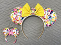 Lemon Blossom Pixie Pair featuring a handcrafted lemon-themed mouse ear headband with sparkling yellow sequin bow and coordinating Mini Magic Charm with matching citrus-inspired design.