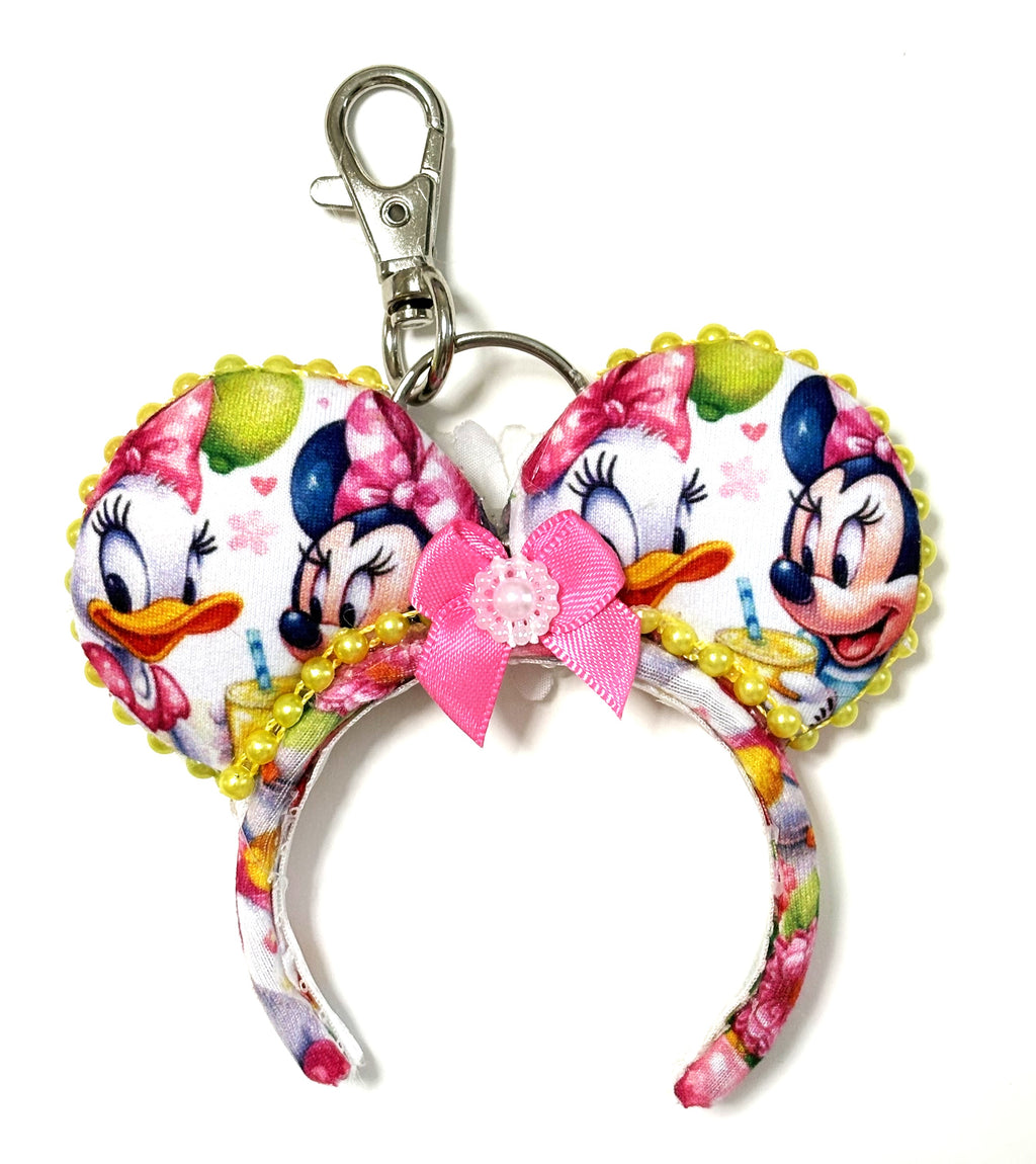 Handcrafted Lemon Blossom Mini Magic Charm featuring citrus-inspired artwork, a pink boutique bow with sparkling accents, a miniature mouse ear design, and a lobster clasp by Pixie Park Company.