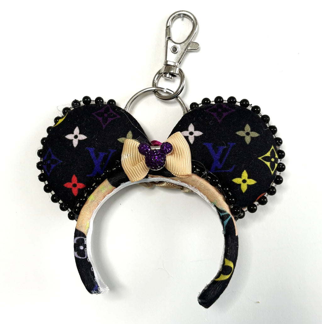 Pixie Park Company Metropolitan Luxe Mini Magic Charm featuring black and neutral fashion-inspired geometric artwork, a shimmering black boutique bow, decorative black beaded trim, and a coordinating keyring attachment.