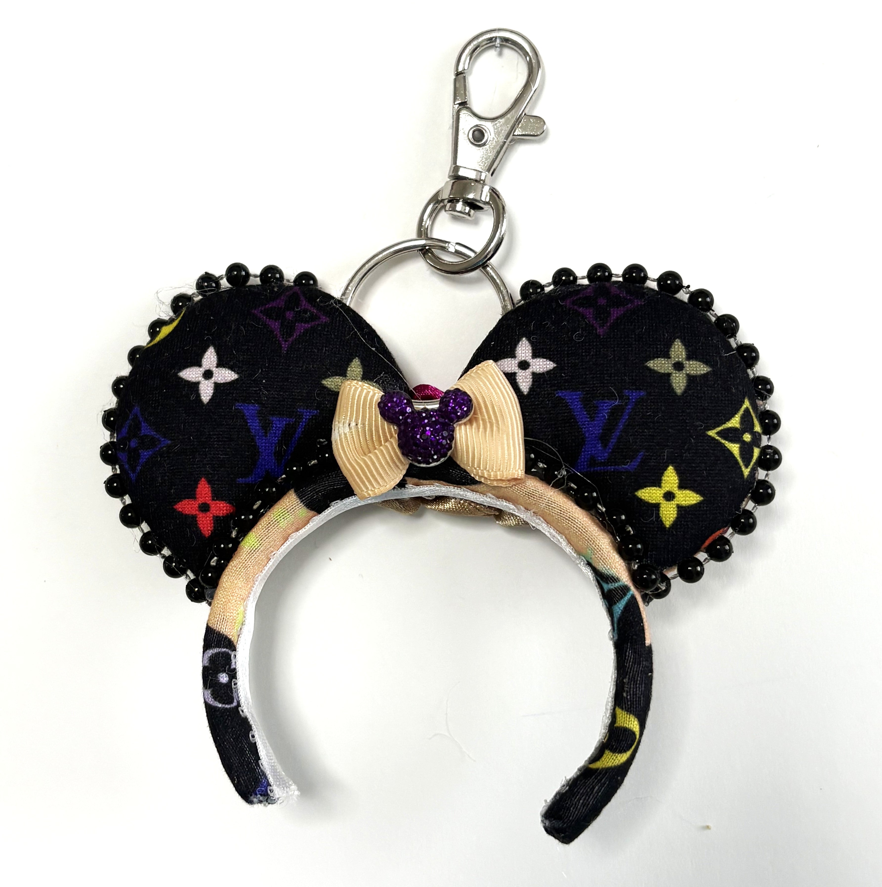 Pixie Park Company Metropolitan Luxe Mini Magic Charm featuring black and neutral fashion-inspired geometric artwork, a shimmering black boutique bow, decorative black beaded trim, and a coordinating keyring attachment.