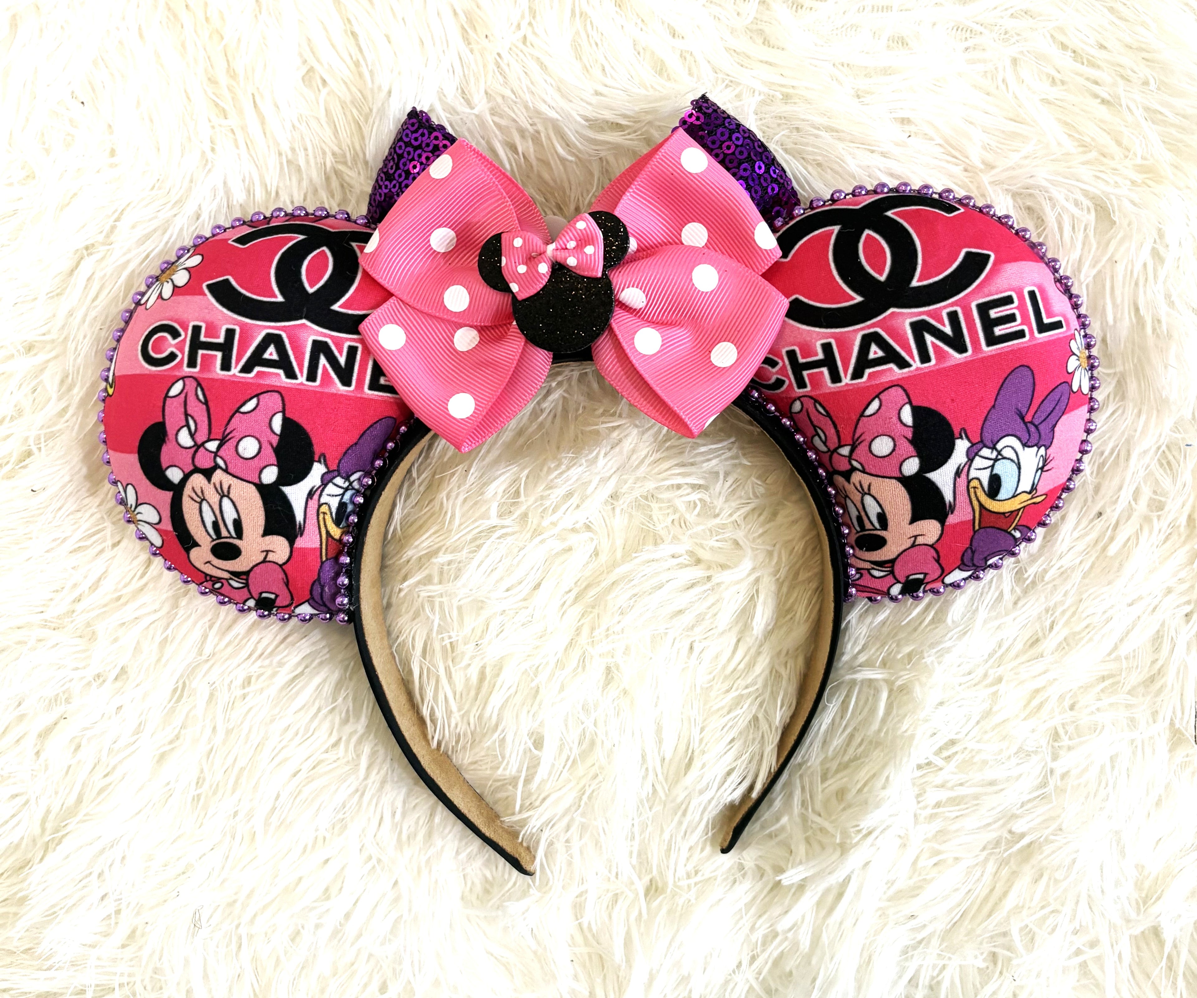 Pixie Park Company Parisian Chic Luxe handcrafted mouse ear headband featuring violet and blush Paris-inspired artwork, a deep purple sequin boutique bow, lavender beaded trim, and elegant boutique styling, photographed against a textured white background.