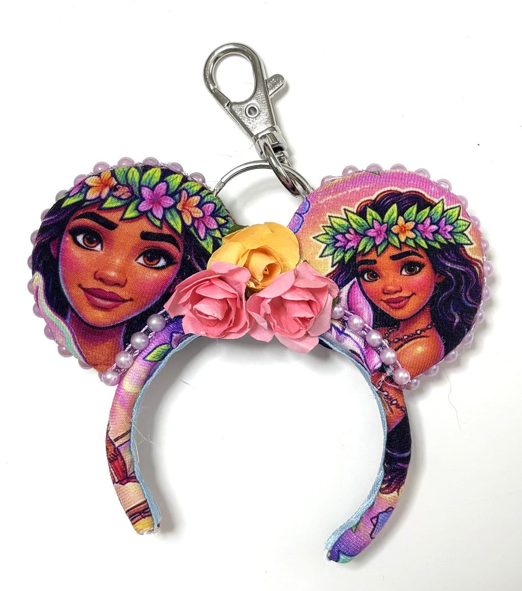 Pixie Park Company Island Spirit Mini Magic Charm featuring tropical island-inspired artwork, a coordinating boutique bow, decorative beaded trim, and a silver keyring with lobster clasp attachment.