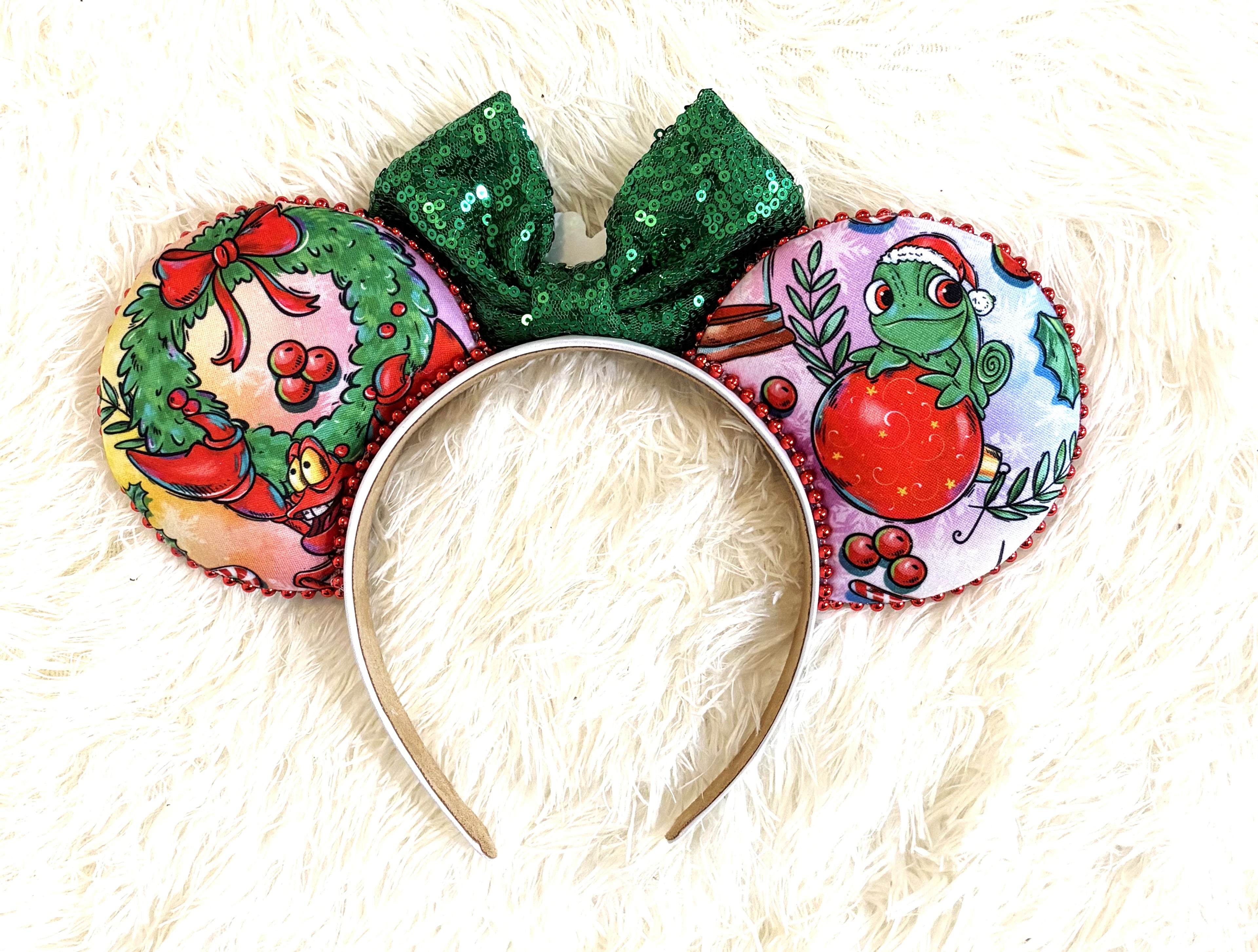 Handcrafted Holiday Magic Signature mouse ear headband featuring festive holiday-inspired artwork, a sparkling green sequined bow, and boutique Christmas styling for magical seasonal adventures.
