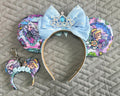 Handcrafted Frost & Fairytales – Princess Duos Pixie Pair featuring a boutique mouse ear headband with a matching Mini Magic Charm inspired by a sparkling winter kingdom and a timeless royal fairy tale.