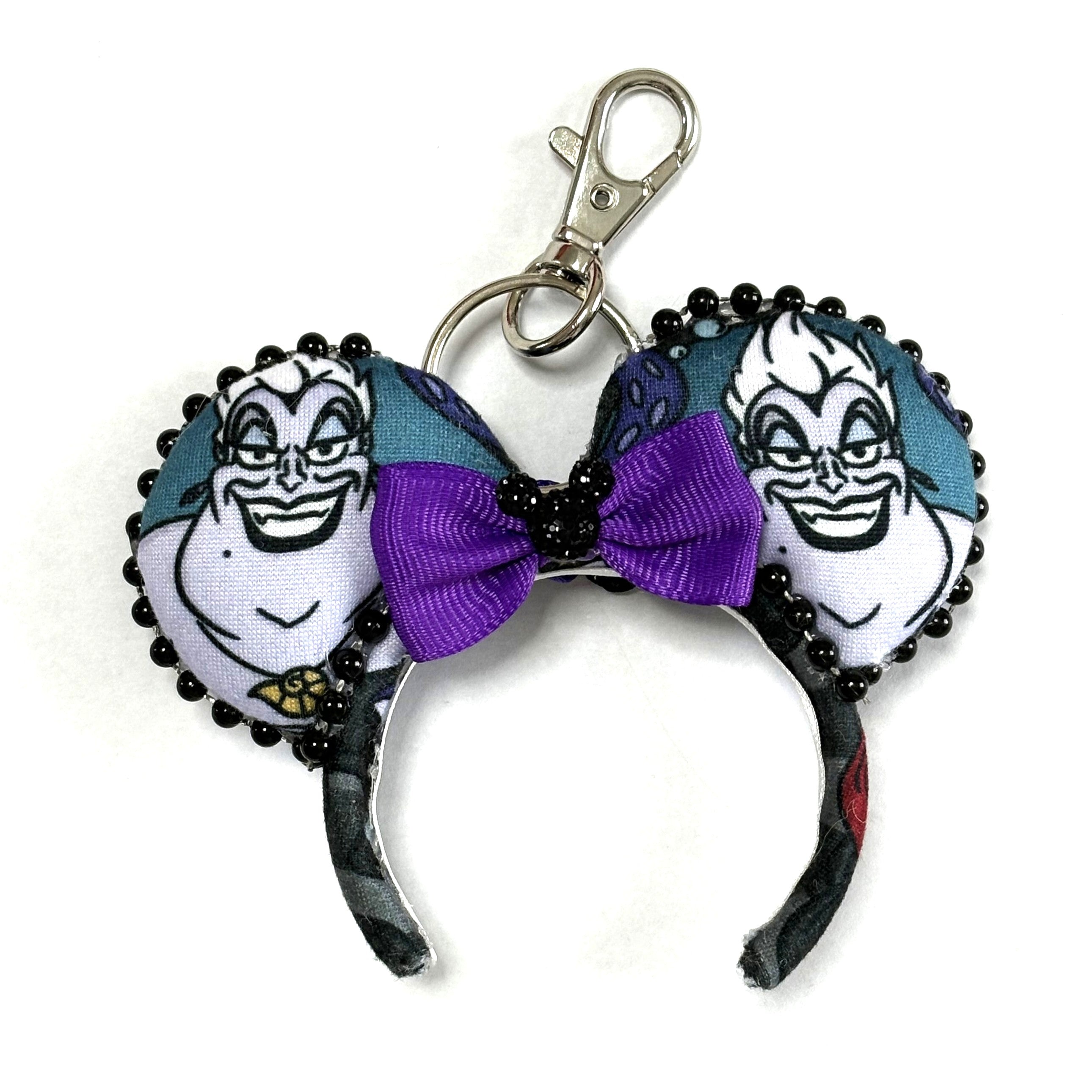 Handcrafted Sea Witch Elegance Mini Magic Charm featuring sea witch-inspired artwork, a shimmering purple sequined bow, and boutique styling by Pixie Park Co
