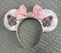 Handcrafted Pink Haunting Signature mouse ear headband featuring ghost-inspired blush plaid fabric, a pink sequined bow, pearl trim, jeweled centerpiece, and boutique craftsmanship for Halloween and autumn park adventures.