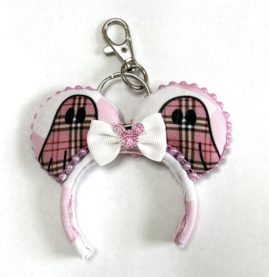 Handcrafted Pink Haunting Mini Magic Charm featuring ghost-inspired blush plaid styling, elegant boutique details, and a secure clasp for backpacks, purses, keys, and Halloween-themed park adventures.