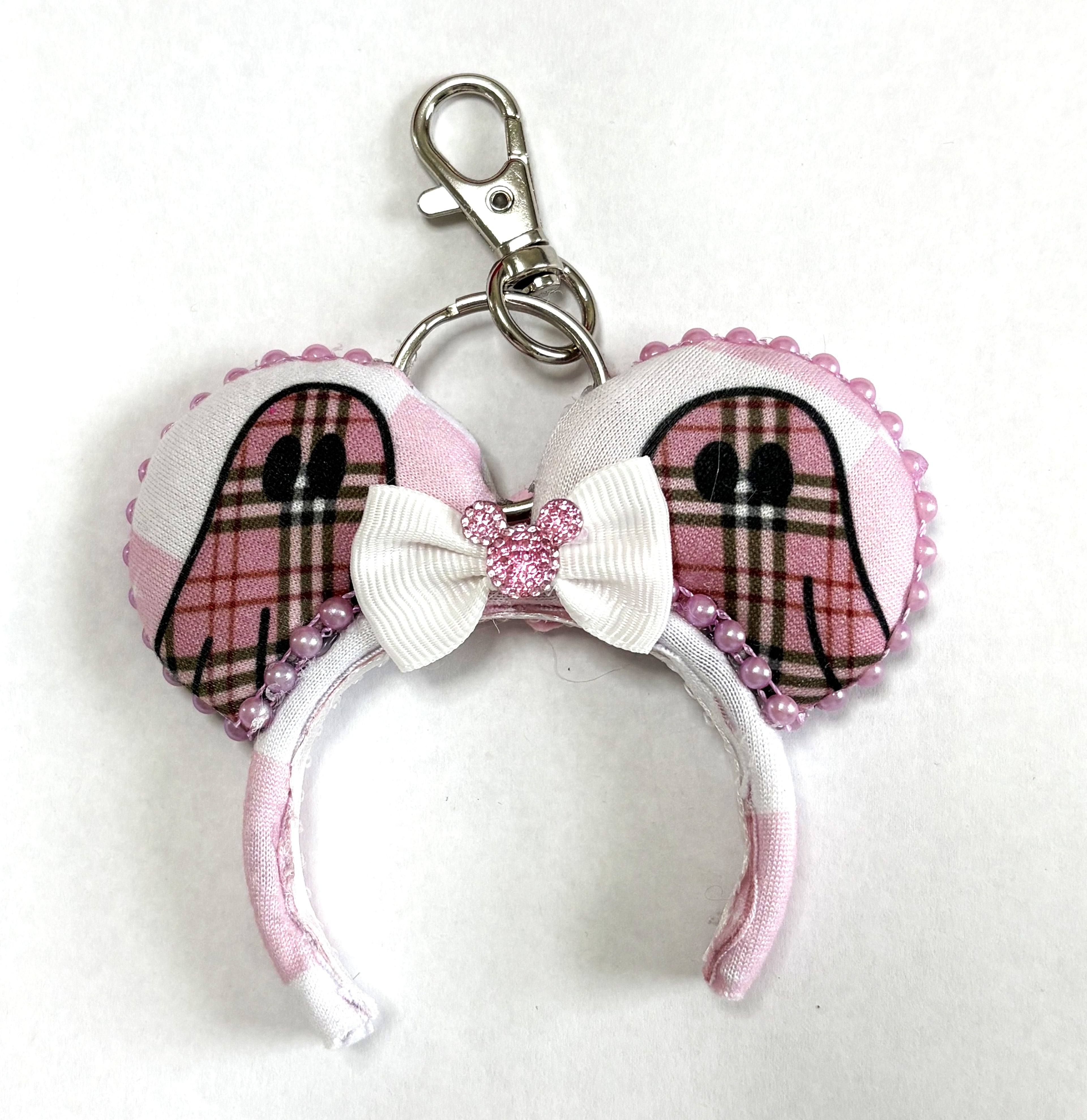 Handcrafted Pink Haunting Mini Magic Charm featuring ghost-inspired blush plaid styling, elegant boutique details, and a secure clasp for backpacks, purses, keys, and Halloween-themed park adventures.