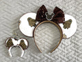 Handcrafted Haunted Couture Pixie Pair featuring coordinated luxury-inspired ghost-themed accessories with elegant neutral tones, boutique detailing, and secure clasps for backpacks, purses, keychains, and Halloween-themed park adventures.