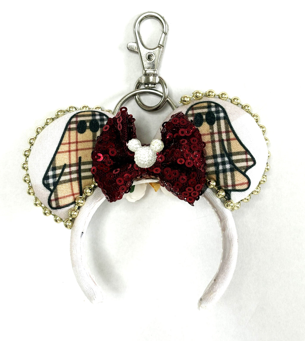 Haunted Elegance handcrafted mini ear charm featuring designer-inspired ghost patterns, burgundy sequin bow, gold trim, lobster clasp and split ring.