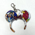 Handcrafted Savanna Royalty Mini Magic Charm featuring colorful lion and savanna-inspired imagery. A playful accessory for bags, backpacks, keys and park adventures.