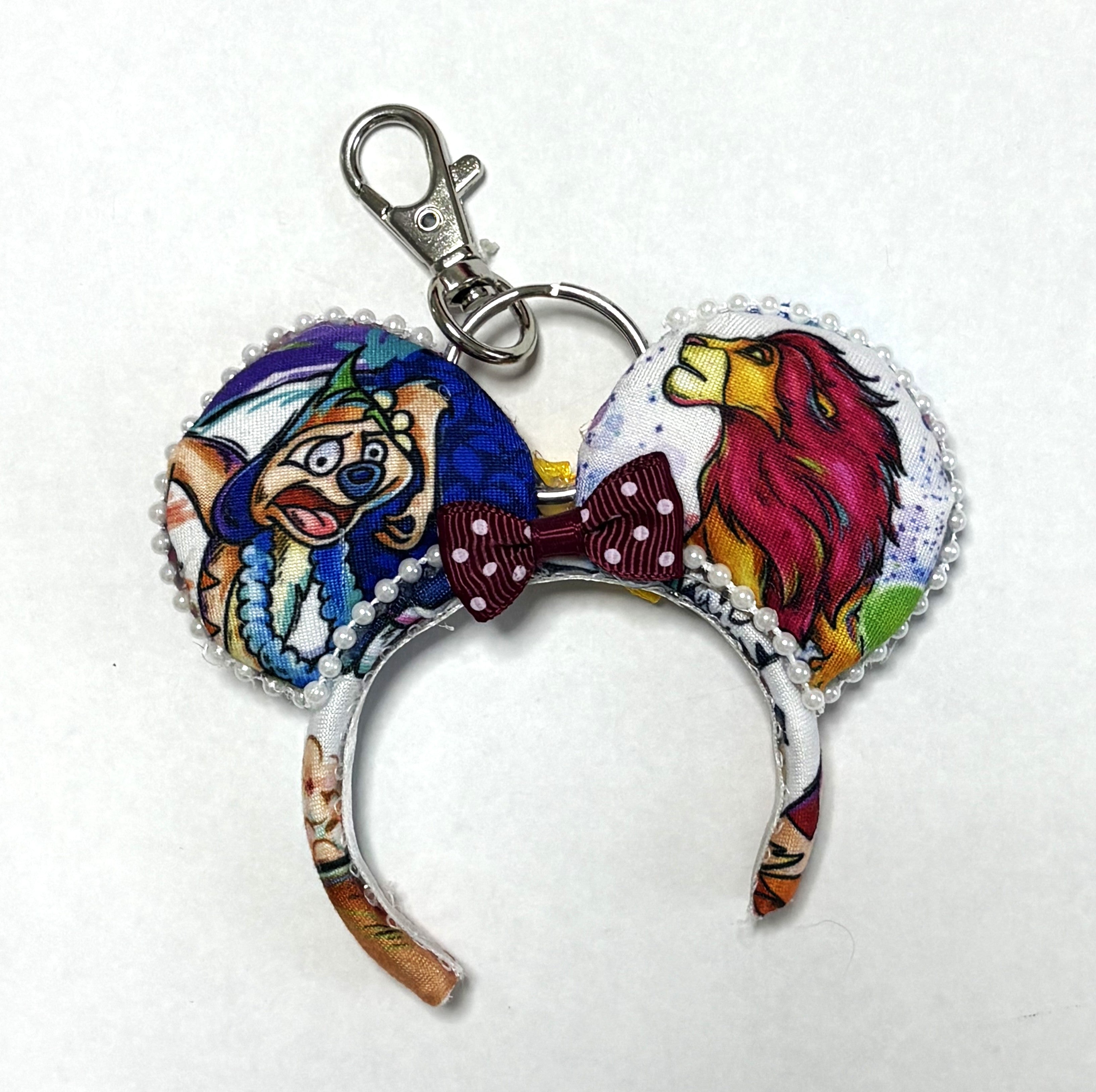 Handcrafted Savanna Royalty Mini Magic Charm featuring colorful lion and savanna-inspired imagery. A playful accessory for bags, backpacks, keys and park adventures.