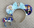 Sisters of Winter Pixie Pair featuring a handcrafted winter-princess-inspired mouse ear headband with sparkling ice-blue bow and matching floral Mini Magic Charm.