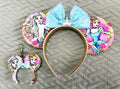 Enchanted Ice & Glass Princess Duo Pixie Pair featuring a handcrafted princess-inspired mouse ear headband with icy-blue sequined bow and crystal crown plus a matching Mini Magic Charm by Pixie Park Co.