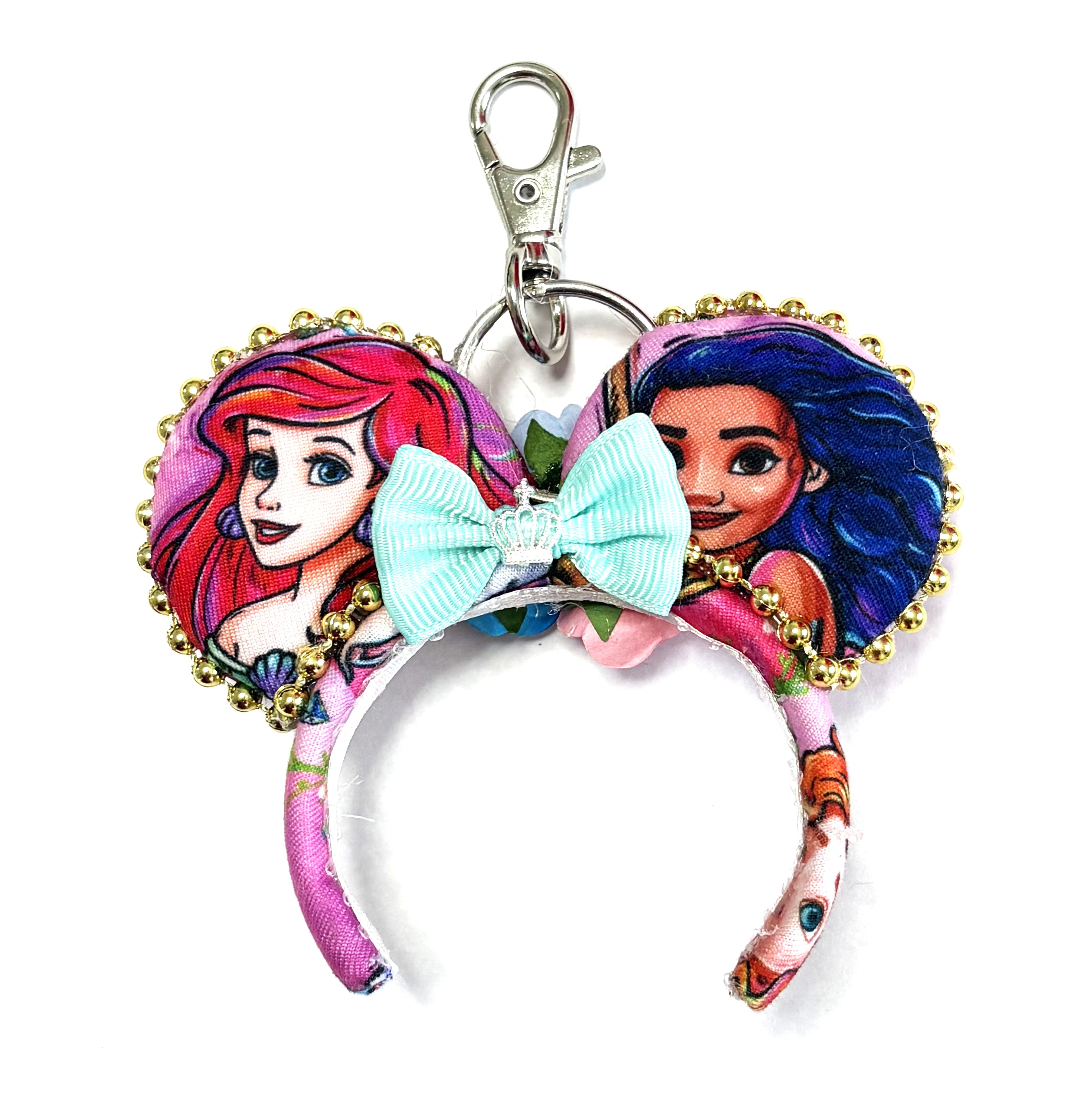Handcrafted Waves & Wishes Princess Duo Mini Magic Charm featuring two ocean princess-inspired mouse ears, an aqua bow, pink floral fabric, and sparkling gold trim by Pixie Park Co.