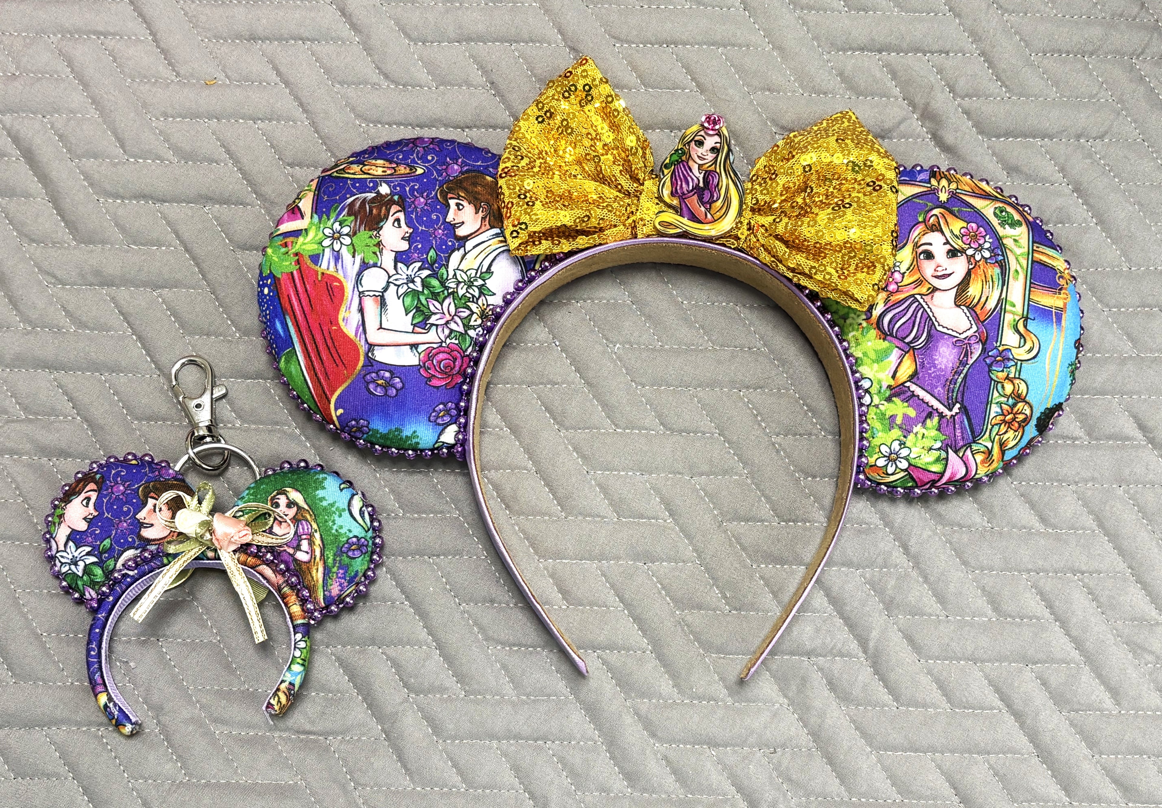 Golden Tower Pixie Pair with handcrafted purple princess-inspired mouse ear headband, sparkling gold bow and matching Mini Magic Charm.