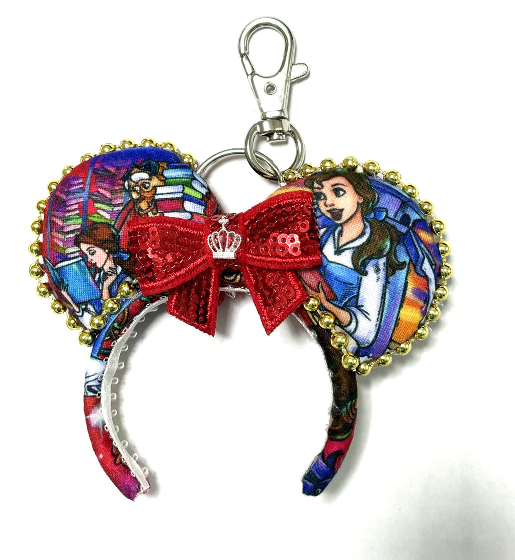 Handcrafted Enchanted Ballroom Mini Magic Charm with colorful princess-inspired storybook ears, gold trim, red sequin bow, crown accent and lobster clasp.
