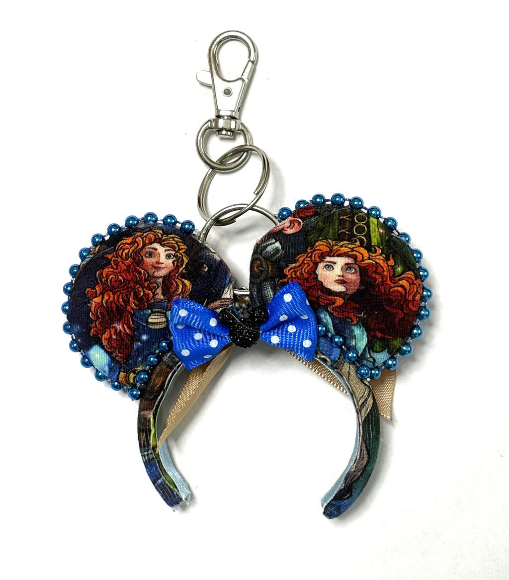 Handcrafted Highland Destiny Mini Magic Charm with Scottish-inspired storybook ears, blue beaded trim, bright-blue polka-dot bow and lobster clasp.